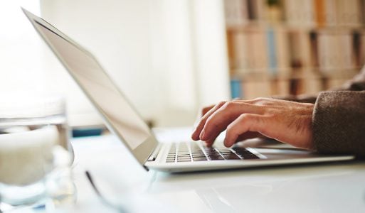 Someone typing on a laptop