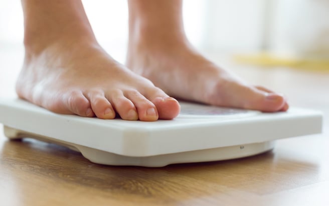Someone standing on scales